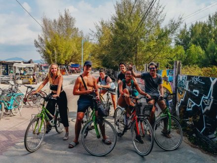 A group on bikes while cycling round the island of Gili Trawangan, Indonesia