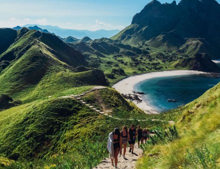 A stunning view of a group hiking up to the top of viewpoint on Gili Lawa in Indonesia 