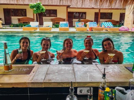A group of girls in the pool with cocktails while on the island Gili Trawangan, Indonesia  