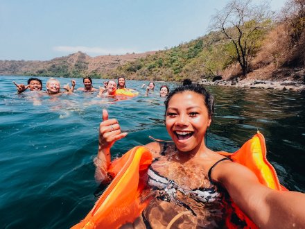 A group taking a selfie while swimming at Lake Toba, a salt water crater in the middle of a super volcano in Indonesia 