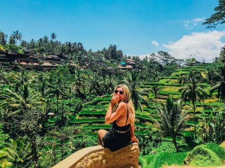 A girl sat admiring the luscious green rice terraces in Ubud, Bali, Indonesia 