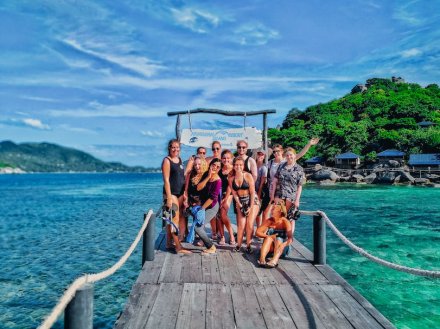 A group photo in Koh Tao by the clear blue water